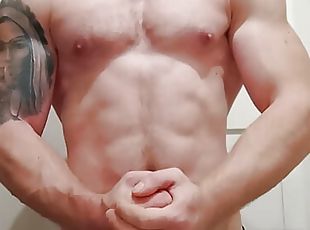 Fitness muscular guy is showing muscles