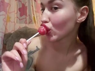 The cutie licks her delicious candy.